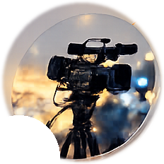 Broadcast camera on a tripod at dusk